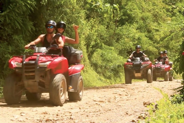 ATVs coming down a dirt road